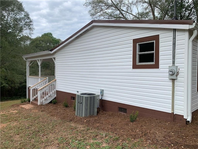 view of side of home with central air condition unit