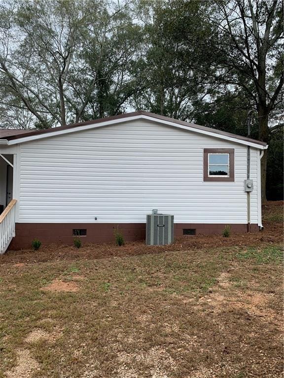 view of property exterior featuring a lawn and cooling unit