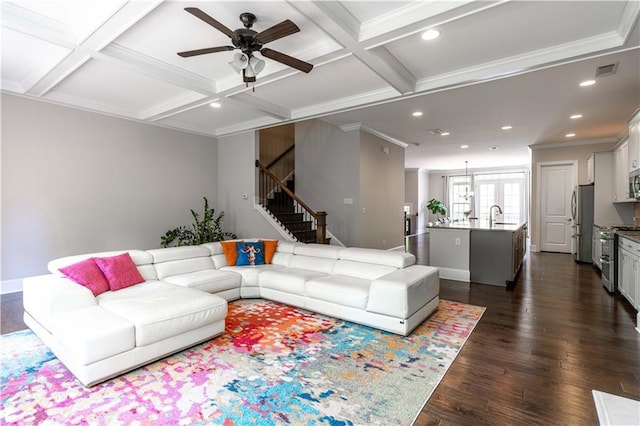 living room with coffered ceiling, sink, crown molding, dark hardwood / wood-style flooring, and beamed ceiling