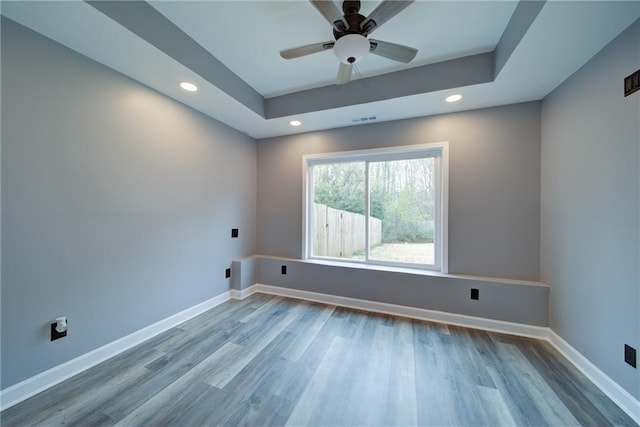 spare room with recessed lighting, wood finished floors, and visible vents