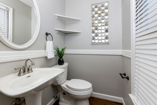 bathroom with wood-type flooring, sink, and toilet