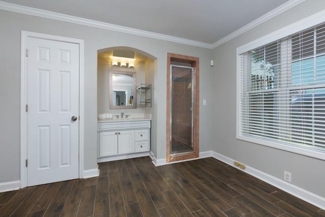 unfurnished bedroom with crown molding, sink, and dark hardwood / wood-style floors