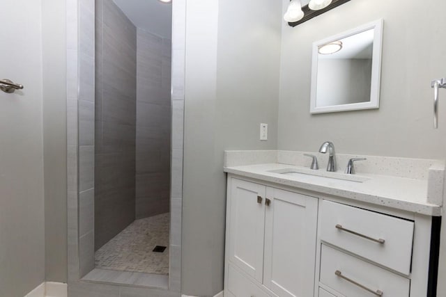 bathroom with vanity and tiled shower