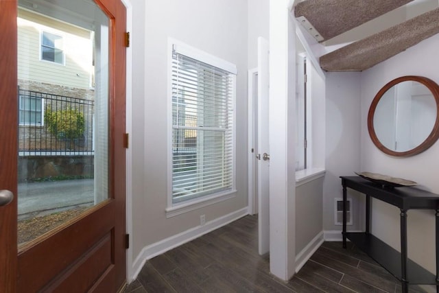 doorway with dark wood-type flooring