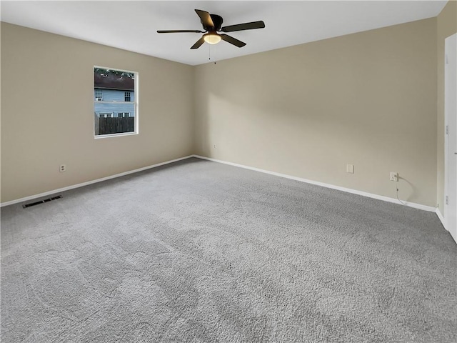 empty room with ceiling fan and carpet floors