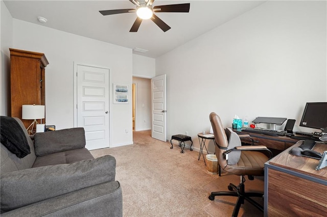 carpeted office space with ceiling fan