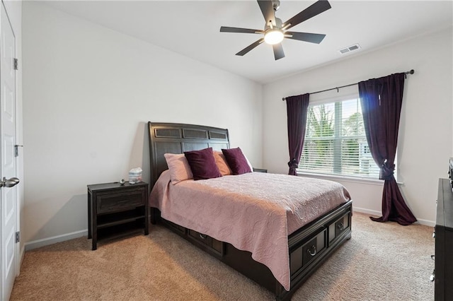 bedroom with ceiling fan and light carpet