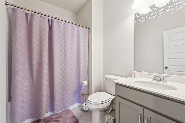 bathroom with vanity, tile patterned floors, and toilet