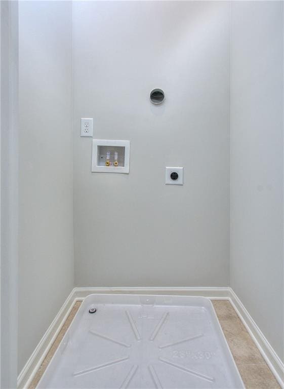 laundry area featuring electric dryer hookup, light tile patterned floors, and hookup for a washing machine