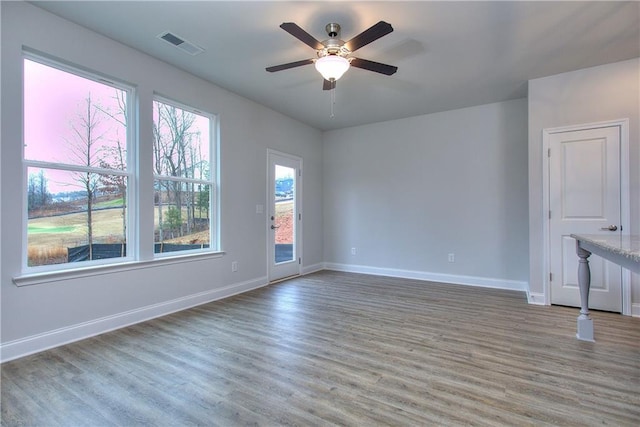 empty room with ceiling fan and wood-type flooring