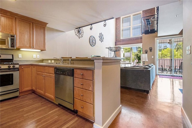 1133 Church St Unit 1, Covington, GA 30014 - kitchen with stainless steel appliances, a peninsula, a sink, open floor plan, and baseboards
