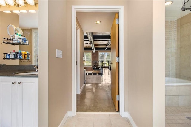 1133 Church St Unit 1, Covington, GA 30014 - corridor featuring a sink, baseboards, recessed lighting, and light tile patterned floors