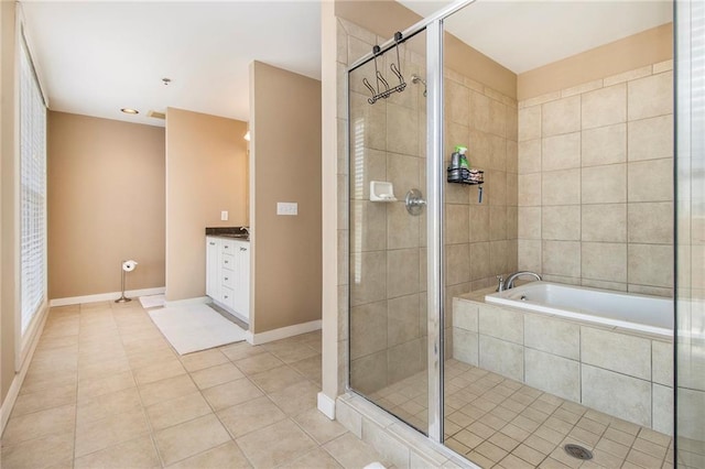 1133 Church St Unit 1, Covington, GA 30014 - bathroom featuring tile patterned floors, a stall shower, vanity, and a garden tub