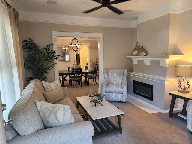 carpeted living room with a textured ceiling and ceiling fan