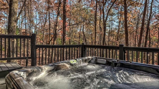 wooden deck with a hot tub