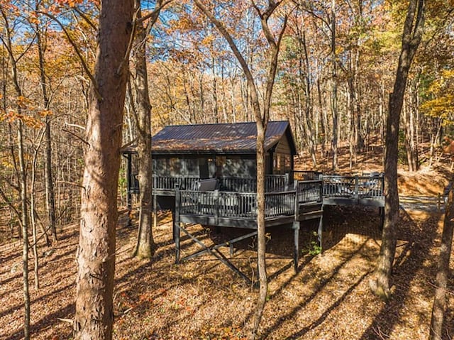 view of outbuilding featuring a view of trees