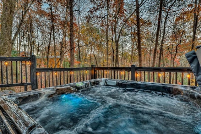 wooden deck featuring a hot tub