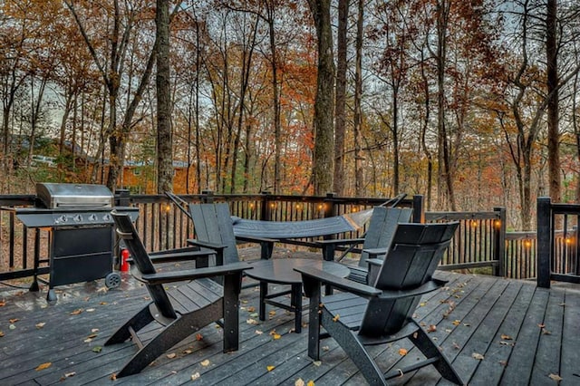 wooden deck featuring a grill