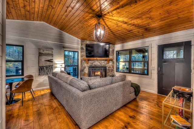 living area featuring a stone fireplace, wood ceiling, lofted ceiling, and wood-type flooring