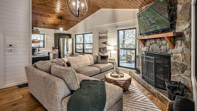 living room with wooden ceiling, hardwood / wood-style flooring, a fireplace, and lofted ceiling