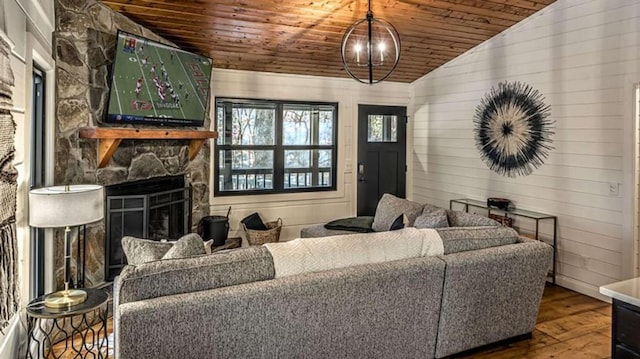 living room featuring vaulted ceiling, wooden ceiling, a fireplace, and hardwood / wood-style flooring