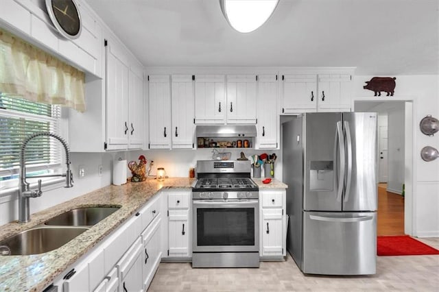 6863 Recreation Ln, Acworth, GA 30102 - kitchen with appliances with stainless steel finishes, a sink, white cabinetry, light stone counters, and light wood-style floors