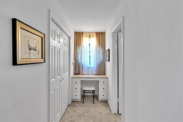 6863 Recreation Ln, Acworth, GA 30102 - corridor featuring light carpet, a desk, and a textured ceiling