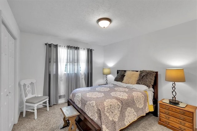 6863 Recreation Ln, Acworth, GA 30102 - bedroom featuring light colored carpet, a textured ceiling, and a closet