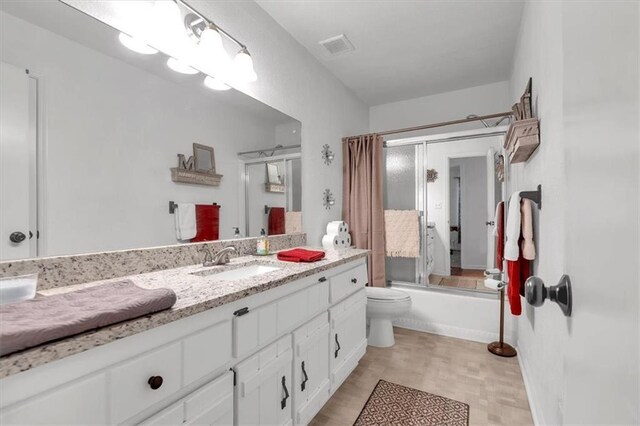 6863 Recreation Ln, Acworth, GA 30102 - bathroom featuring toilet, vanity, and shower / bath combination with glass door