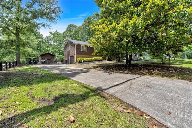 6863 Recreation Ln, Acworth, GA 30102 - view of front of home with concrete driveway, a garage, and an outbuilding
