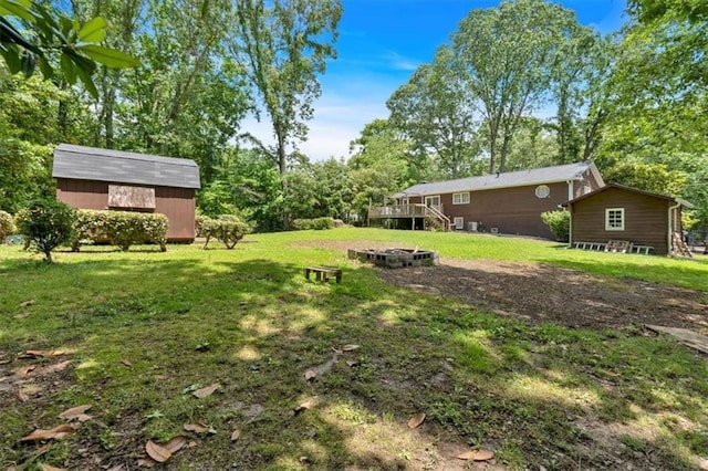 6863 Recreation Ln, Acworth, GA 30102 - view of grassy yard featuring an outdoor fire pit and a wooden deck