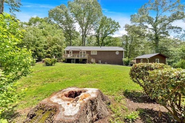 6863 Recreation Ln, Acworth, GA 30102 - view of green lawn featuring a wooden deck, a fire pit, and stairs