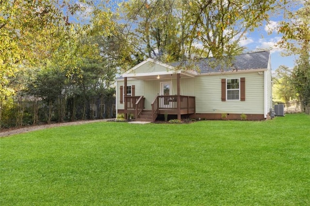 rear view of house with central AC, a lawn, and a deck