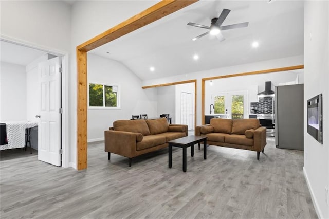 living room with vaulted ceiling, ceiling fan, light hardwood / wood-style floors, and french doors