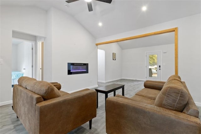 living room featuring vaulted ceiling, ceiling fan, and light wood-type flooring