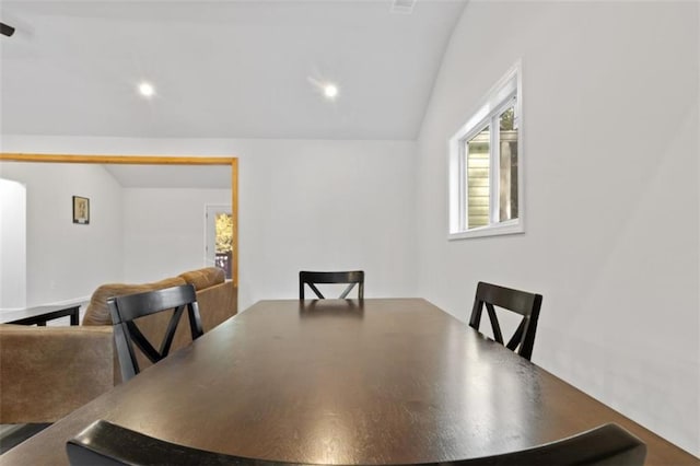 dining area featuring vaulted ceiling