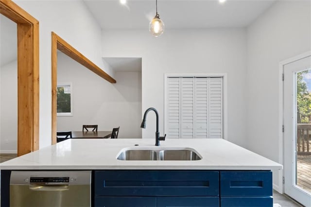 kitchen with sink, dishwasher, a kitchen island with sink, blue cabinets, and decorative light fixtures