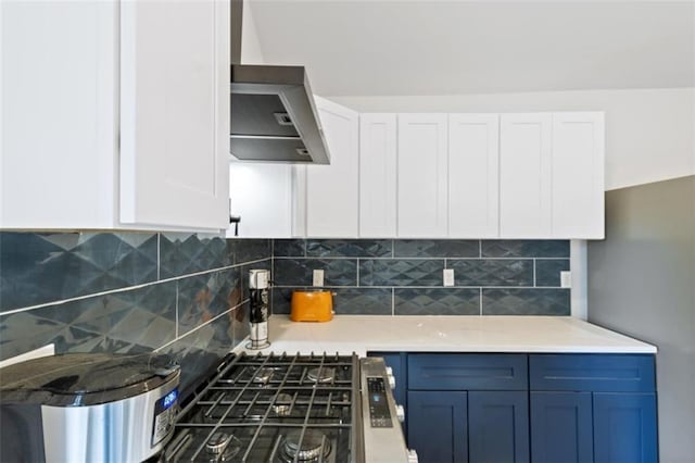 kitchen with tasteful backsplash, white cabinetry, and blue cabinetry