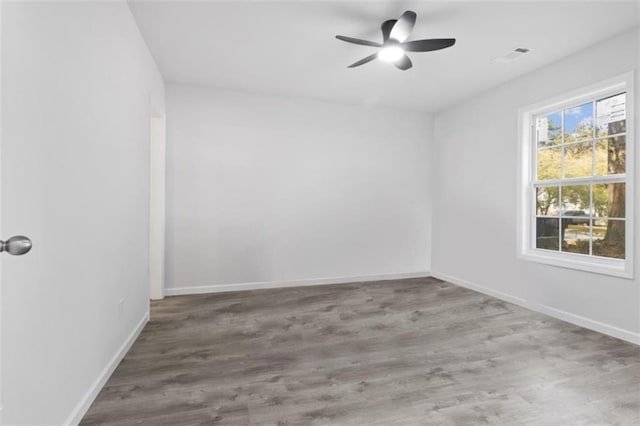 empty room featuring hardwood / wood-style flooring and ceiling fan