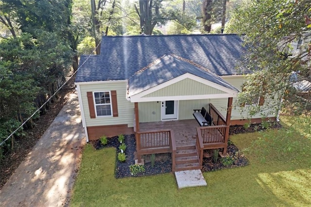 exterior space featuring a wooden deck and a front yard