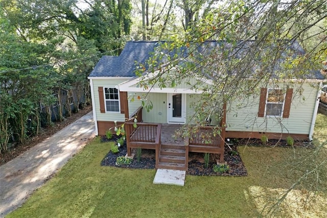 rear view of house featuring a yard