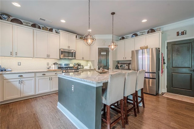 285 Turtle Rock Pl, Acworth, GA 30101 - kitchen featuring stainless steel appliances, backsplash, dark wood-style floors, white cabinetry, and crown molding
