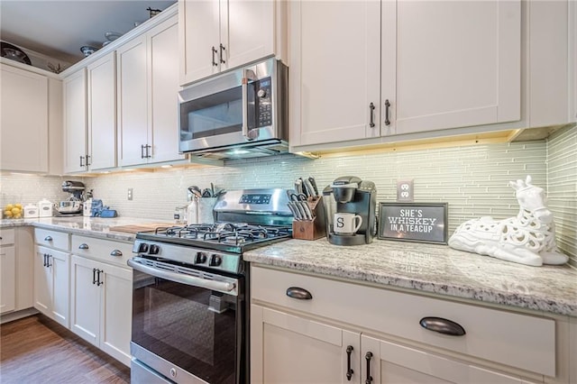285 Turtle Rock Pl, Acworth, GA 30101 - kitchen featuring stainless steel appliances, white cabinetry, and light stone counters