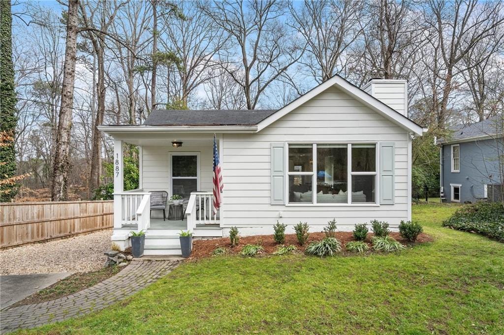 bungalow-style home featuring a porch and a front yard