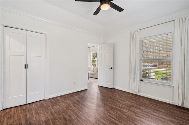 unfurnished bedroom featuring ceiling fan, ornamental molding, and dark hardwood / wood-style floors