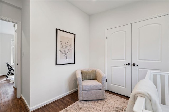 sitting room with wood-type flooring