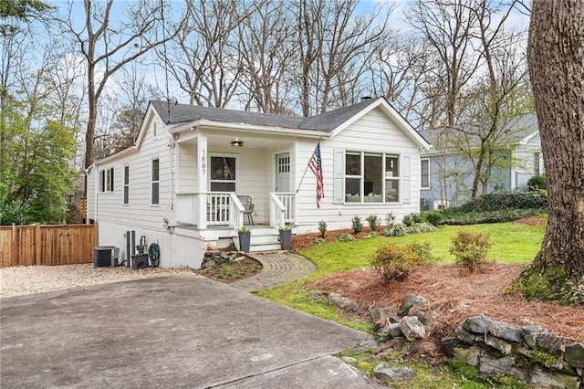 view of front of property with a front yard and central air condition unit