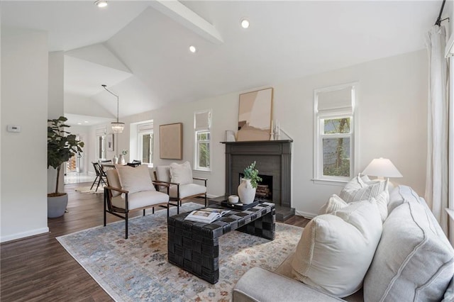 living room featuring dark hardwood / wood-style floors and vaulted ceiling