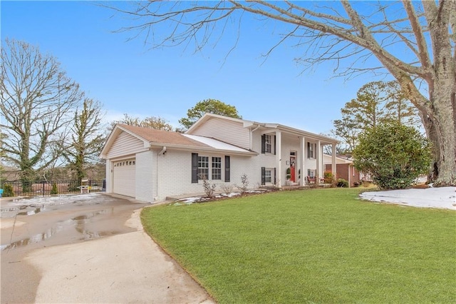 split level home featuring a front yard and a garage