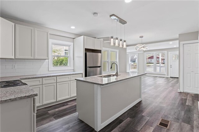 599 Daniel Ave, Decatur, GA 30032 - kitchen featuring visible vents, light stone countertops, a sink, and freestanding refrigerator